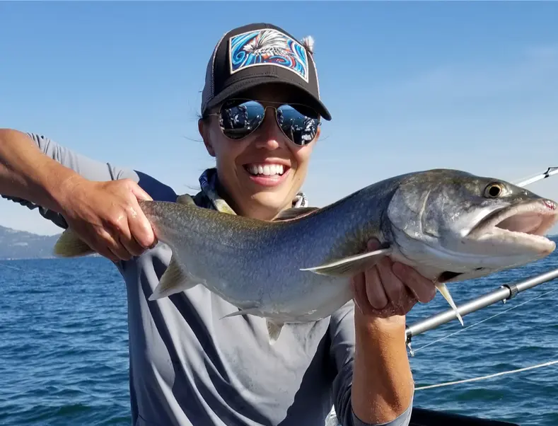 Happy angler posing with a great catch on a Flathead Lake fishing charter